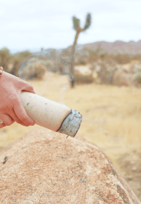 A moxa stick held over desert rock